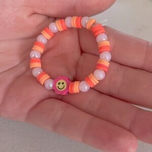 Smiley face braclet orange and pink